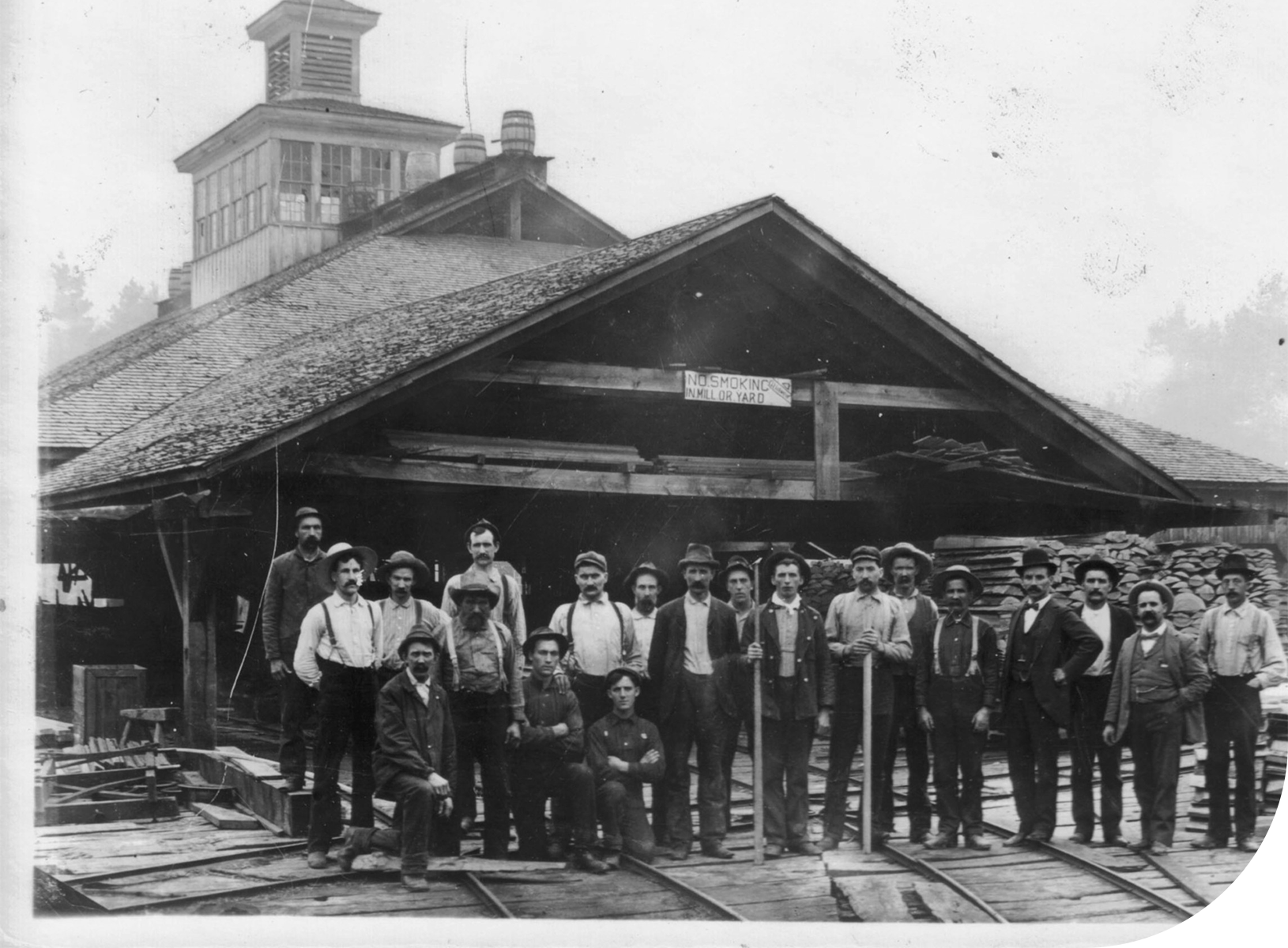Historical black and white photo of workers at Collins sawmill